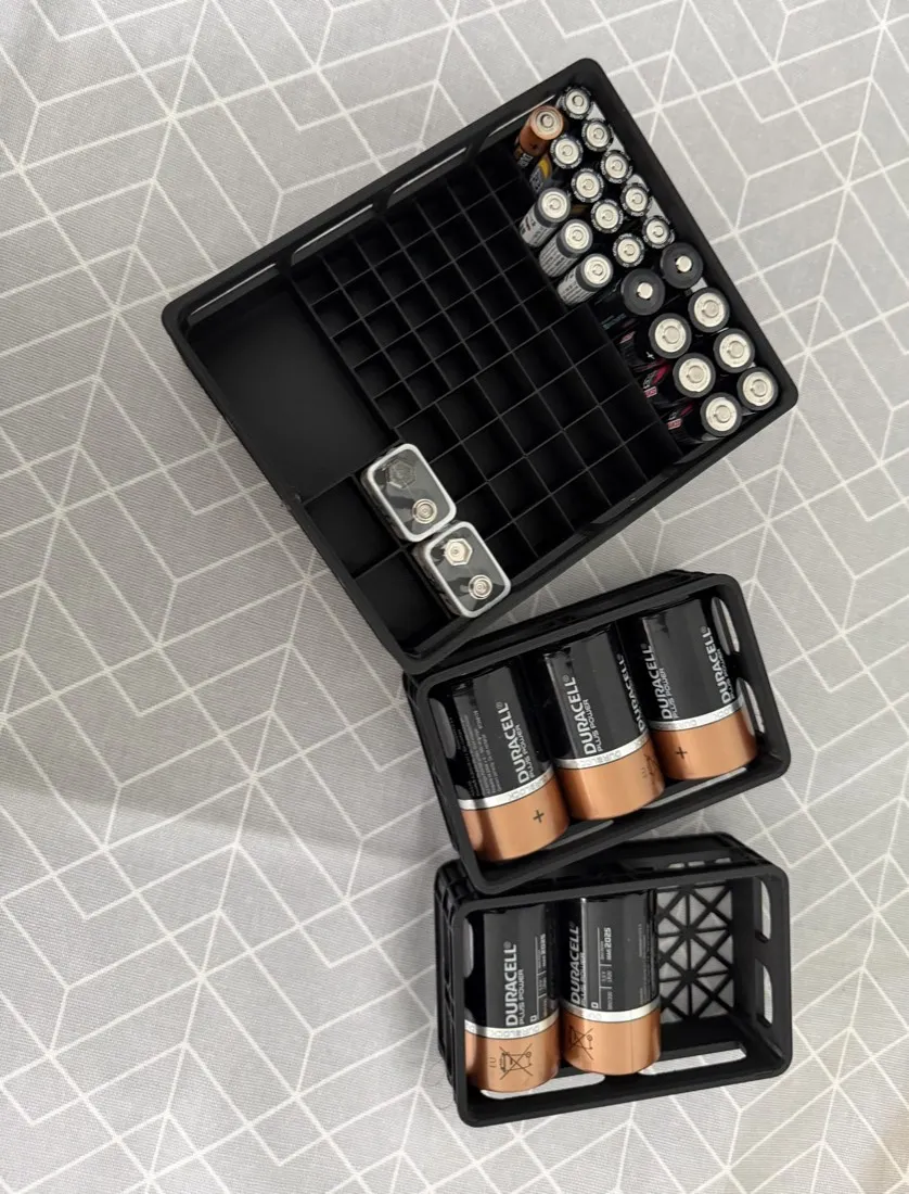 3D-printed Battery Caddy in black holding AA, AAA, 9V, C and D batteries